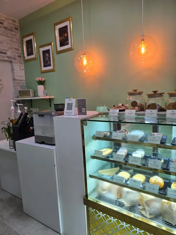 Inside Moi Doughssier — the illuminated display case filled with fresh pastries and cakes